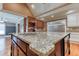 Close-up of the kitchen island featuring granite countertops and a stainless steel sink at 2680 Bay Ridge Dr, Loganville, GA 30052