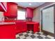 Laundry room featuring red cabinets, laminate counter tops, black and white tile flooring at 2680 Bay Ridge Dr, Loganville, GA 30052