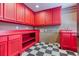 Laundry room featuring red cabinets, laminate counter tops, black and white tile flooring at 2680 Bay Ridge Dr, Loganville, GA 30052