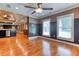 Hardwood flooring flows from kitchen to the living room with neutral walls, ceiling fan, and open floor plan at 2680 Bay Ridge Dr, Loganville, GA 30052