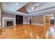 Living room featuring hardwood floors, a stone fireplace, and a custom built-in bookshelf at 2680 Bay Ridge Dr, Loganville, GA 30052