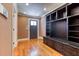 Mudroom featuring hardwood floors, built-in shelving, bench, and a paneled front door at 2680 Bay Ridge Dr, Loganville, GA 30052