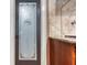 Kitchen pantry featuring decorative glass door, granite countertops and dark wood cabinets at 2680 Bay Ridge Dr, Loganville, GA 30052
