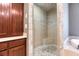 Close-up of corner shower featuring tile walls, small seat, and a tiled ceiling at 2680 Bay Ridge Dr, Loganville, GA 30052