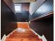 Staircase with hardwood steps and dark-painted walls leads to the upper or lower level of the house at 2680 Bay Ridge Dr, Loganville, GA 30052