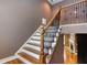 View of a staircase with wood and wrought iron spindles and wood railing at 2680 Bay Ridge Dr, Loganville, GA 30052