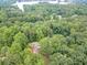 An aerial view shows this home surrounded by mature trees with a long driveway for added privacy at 3329 Walt Stephens Rd, Stockbridge, GA 30281