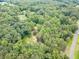 Overhead view showcasing a house nestled among lush, mature trees in a serene, heavily-wooded area at 3329 Walt Stephens Rd, Stockbridge, GA 30281