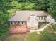 Aerial view showcasing a cozy home with a large wooden deck surrounded by trees at 3329 Walt Stephens Rd, Stockbridge, GA 30281