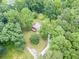 An aerial view of the property shows the home surrounded by lush mature trees at 3329 Walt Stephens Rd, Stockbridge, GA 30281