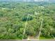 Expansive aerial view showcasing a large, heavily wooded lot, outlined in white at 3329 Walt Stephens Rd, Stockbridge, GA 30281