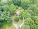 Aerial shot of a charming home with a wooden deck, secluded among lush, mature trees and greenery at 3329 Walt Stephens Rd, Stockbridge, GA 30281