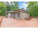 A spacious wooden deck surrounds the house with wood railings and a green door to enter the house at 3329 Walt Stephens Rd, Stockbridge, GA 30281