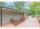 Long wooden deck, with wood railings, surrounds the back of this home with light green siding at 3329 Walt Stephens Rd, Stockbridge, GA 30281