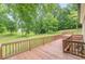 Spacious back deck with wood railings overlooking the beautiful backyard and mature trees at 3329 Walt Stephens Rd, Stockbridge, GA 30281