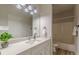 Bathroom featuring white cabinetry, quartz countertop, tub/shower, and decorative green plant at 3329 Walt Stephens Rd, Stockbridge, GA 30281