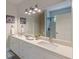 Bathroom featuring double sinks, large mirrors, and updated lighting at 3329 Walt Stephens Rd, Stockbridge, GA 30281