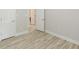 Bedroom with wood-look laminate flooring and white doors at 3329 Walt Stephens Rd, Stockbridge, GA 30281