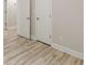 Bedroom features wood-look laminate flooring and white doors at 3329 Walt Stephens Rd, Stockbridge, GA 30281
