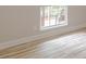 Bright bedroom featuring wood-look floors, a window to deck, and neutral walls at 3329 Walt Stephens Rd, Stockbridge, GA 30281