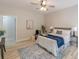 Bright bedroom with ceiling fan, wood-look flooring, and a view into an adjoining bathroom at 3329 Walt Stephens Rd, Stockbridge, GA 30281