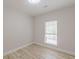 Bright bedroom featuring modern wood-look floors, large window, and neutral walls at 3329 Walt Stephens Rd, Stockbridge, GA 30281