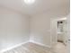 A bright, empty bedroom with light-colored walls, modern floors, and an adjacent bathroom at 3329 Walt Stephens Rd, Stockbridge, GA 30281