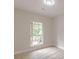 Bright bedroom features wood-look laminate flooring, white trim, and view of the outdoor deck at 3329 Walt Stephens Rd, Stockbridge, GA 30281