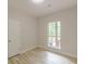 Cozy bedroom featuring wood-look floors, a window to trees, and neutral walls at 3329 Walt Stephens Rd, Stockbridge, GA 30281