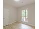Bedroom with wood-look laminate flooring and view of the outdoor deck at 3329 Walt Stephens Rd, Stockbridge, GA 30281