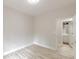 Bedroom with wood-look laminate flooring and doorway to bathroom with white vanity at 3329 Walt Stephens Rd, Stockbridge, GA 30281