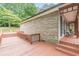 Wooden deck extends from the brick house with an outdoor seating area at 3329 Walt Stephens Rd, Stockbridge, GA 30281
