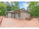 Large wooden deck wraps around the side of the house and connects with green doors at 3329 Walt Stephens Rd, Stockbridge, GA 30281