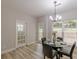 Dining area with modern chandelier, outdoor view, and lots of natural light at 3329 Walt Stephens Rd, Stockbridge, GA 30281