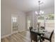Bright dining area featuring a modern chandelier and views of the backyard at 3329 Walt Stephens Rd, Stockbridge, GA 30281