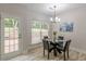 Dining area with a chandelier and a glass door leading to the deck at 3329 Walt Stephens Rd, Stockbridge, GA 30281
