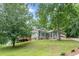 Charming home with brick accents, lush landscaping, and a lovely elevated wooden deck at 3329 Walt Stephens Rd, Stockbridge, GA 30281
