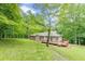 Landscaped yard and house with a large wooden deck at 3329 Walt Stephens Rd, Stockbridge, GA 30281