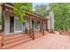 Spacious front porch with seating, stylish trim, and a welcoming entrance at 3329 Walt Stephens Rd, Stockbridge, GA 30281