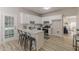 Open kitchen with island seating that flows into an airy dining area and living space at 3329 Walt Stephens Rd, Stockbridge, GA 30281