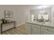 Open kitchen view with white cabinets and an island, looking towards a dining area at 3329 Walt Stephens Rd, Stockbridge, GA 30281