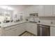 Modern kitchen with white cabinets, white subway tile backsplash, and stainless steel appliances at 3329 Walt Stephens Rd, Stockbridge, GA 30281