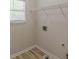 An efficient laundry room featuring a window, upper shelving, and utility connections at 3329 Walt Stephens Rd, Stockbridge, GA 30281