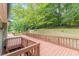 Wooden deck wraps around the side of the home and leads to lush yard at 3329 Walt Stephens Rd, Stockbridge, GA 30281