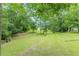 Sprawling green yard is partially shaded by mature trees at 3329 Walt Stephens Rd, Stockbridge, GA 30281
