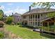 Back exterior view of a spacious home with well-maintained lawn, a deck and screened-in porch at 4120 Abingdon, Cumming, GA 30041