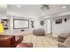 Finished basement with large screen, comfortable seating, and built-in bookshelves at 4120 Abingdon, Cumming, GA 30041