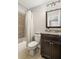 Bathroom with shower, granite counters, dark wood cabinets, toilet and square mirror at 4120 Abingdon, Cumming, GA 30041