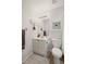 Bathroom featuring single sink vanity, mirrored cabinet, toilet, and tiled floor at 4120 Abingdon, Cumming, GA 30041