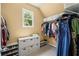 Well-organized closet with shelving, hanging rods, storage bins, and natural light from the window at 4120 Abingdon, Cumming, GA 30041